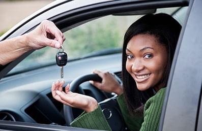 Girl getting handed car keys